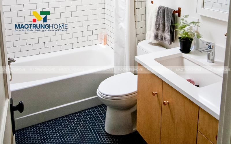 Nhà vệ sinh tối giản với bồn tắm trắng cùng tủ gỗ 
