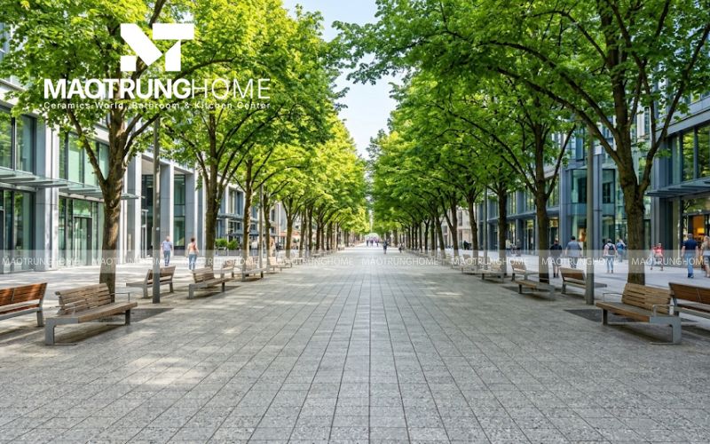 Phối cảnh vỉa hè gạch Terrazzo xám dưới hàng cây rợp bóng mát.