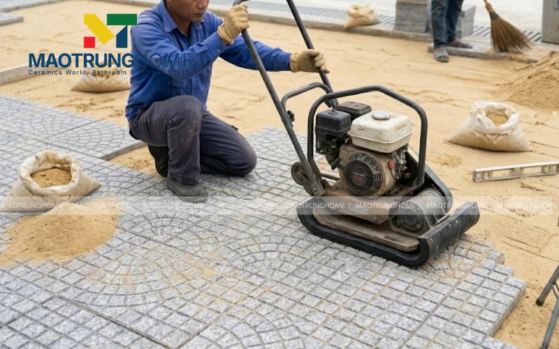 Công đoạn đầm gạch sau khi lát để đảm bảo độ bền và khả năng chịu lực cho công trình